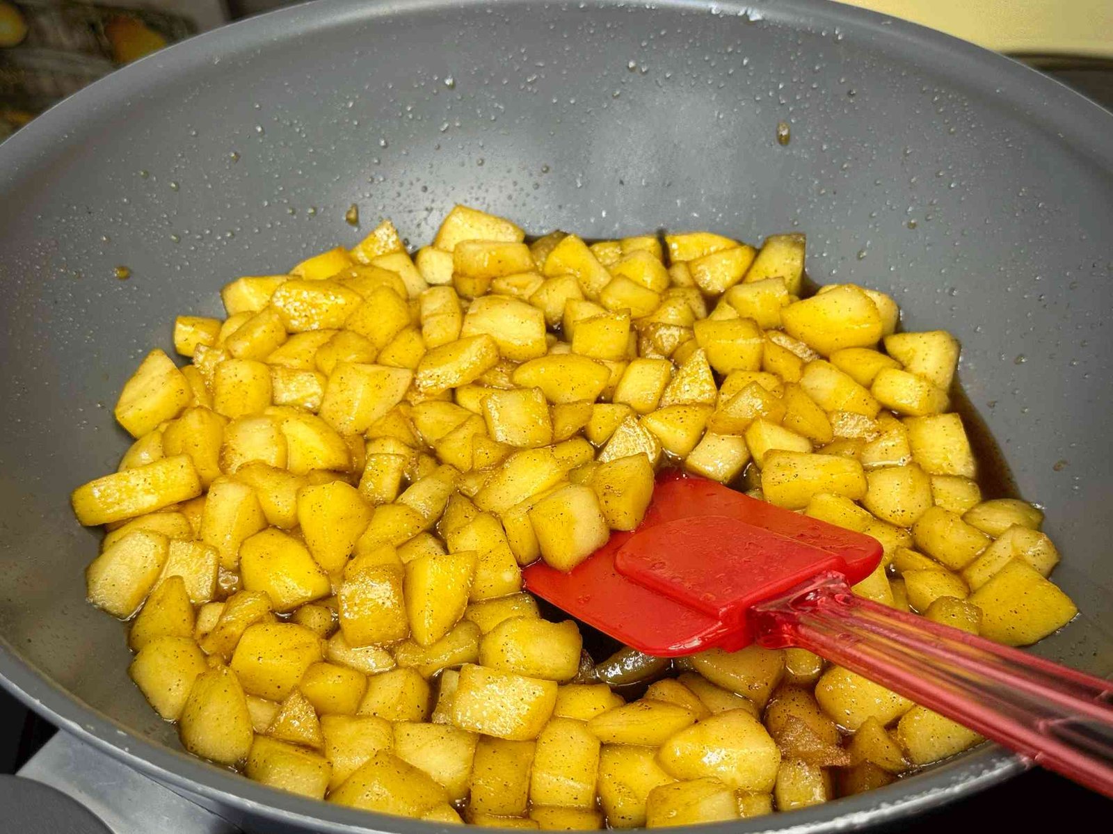 Kockice jabuka se karamelizuju sa cimetom u tavi kako bi se napravio sočan fil za tart.