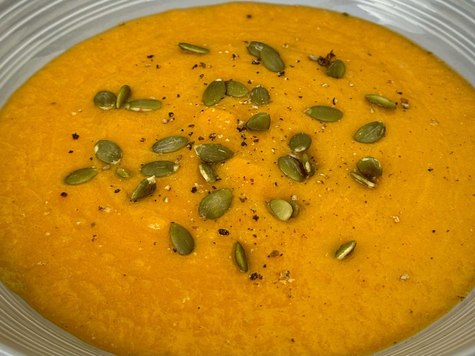 potaz-od-bundeve Narandžasti potaž od bundeve posut hrskavim sjemenkama golice.